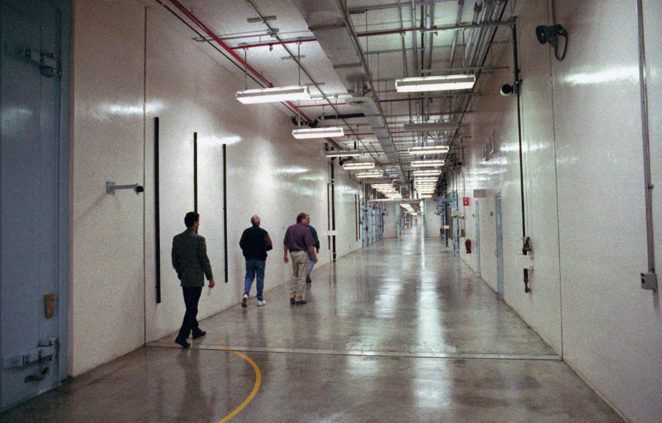 FILE - In this 1997 file photo a group of people walk down a hallway which winds through the Device Assembly Facility which houses 30 separate buildings at the Nevada Test Site in Mercury, Nev. A federal appeals court has ruled against Nevada in a legal battle over the U.S. government's secret shipment of weapons-grade plutonium to a site near Las Vegas. A three-judge panel of the 9th U.S. Circuit Court of Appeals on Tuesday, Aug. 13, 2019, denied the state's appeal after a judge refused to block any future shipments to Nevada. The court in San Francisco says the matter is moot because the Energy Department already sent the radioactive material and has promised that no more will be hauled there. (AP Photo/Lennox McLendon, File)