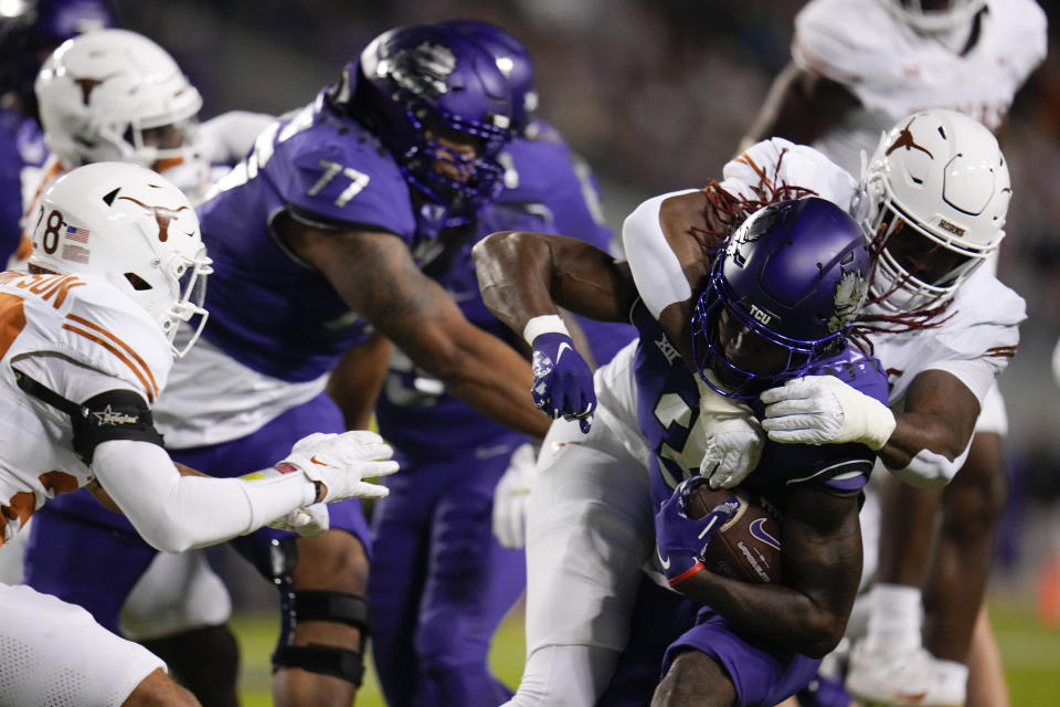 Texas defensive lineman Vernon Broughton, right, tackles TCU wide receiver Savion Williams during the first half of an NCAA college football game, Saturday, Nov. 11, 2023, in Fort Worth, Texas. (AP Photo/Julio Cortez)