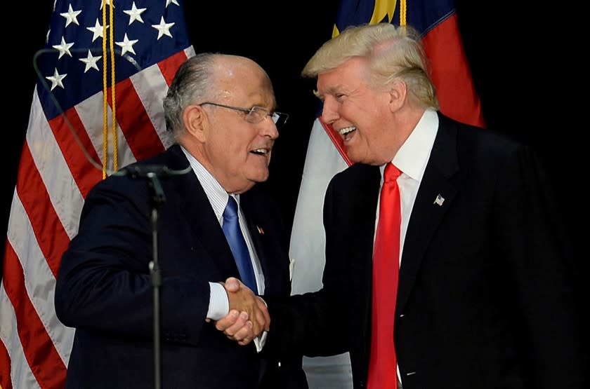 Former New York City mayor Rudy Giuliani, left, welcomes then-Republican presidential candidate Donald Trump on stage during a campaign rally on August 18, 2016, at the Charlotte Convention Center in Charlotte, N.C. (Jeff Siner/Charlotte Observer/TNS) ** OUTS - ELSENT, FPG, TCN - OUTS **