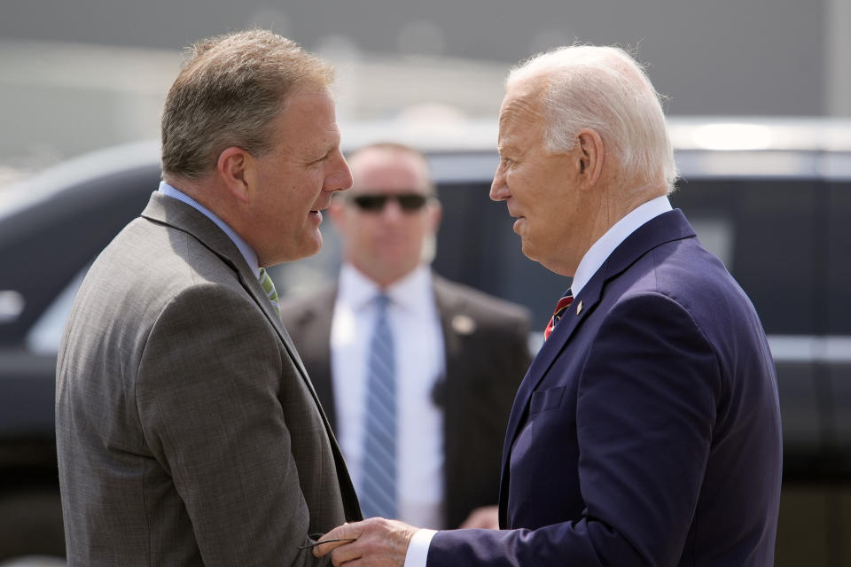 President Joe Biden is greeted by Gov. Chris Sununu, R-N.H., as he arrives on Air Force One at Manchester-Boston Regional Airport, Tuesday, May 21, 2024, in Manchester, N.H. (AP Photo/Alex Brandon)