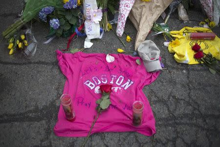 Well-wishers leave a shirt at a make-shift memorial on Boylston Street a day after two explosions hit the Boston Marathon in Boston, Massachusetts in this April 16, 2013 file photo. REUTERS/Adrees Latif/Files