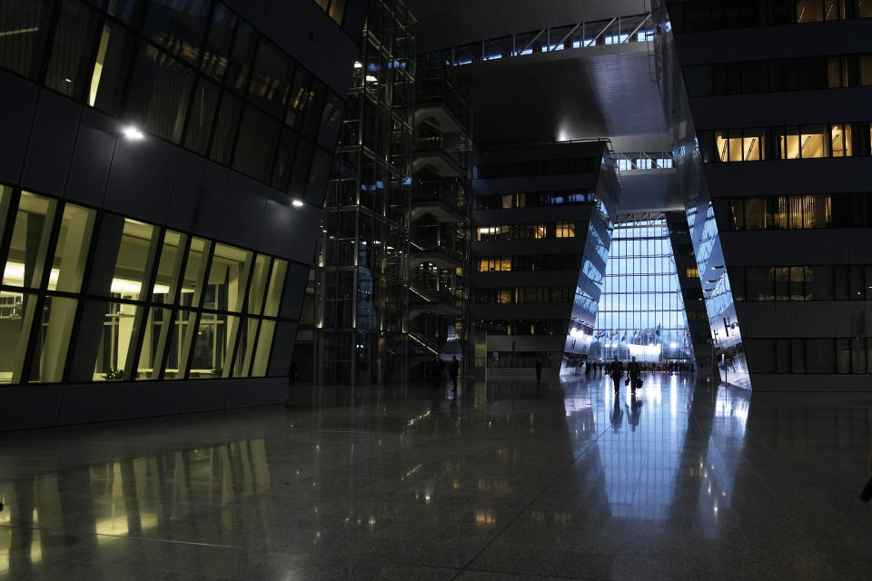 People walk in the corridor prior to a meeting of the North Atlantic Council in defense ministers session at NATO headquarters in Brussels, Thursday, Feb. 15, 2024. (AP Photo/Virginia Mayo)