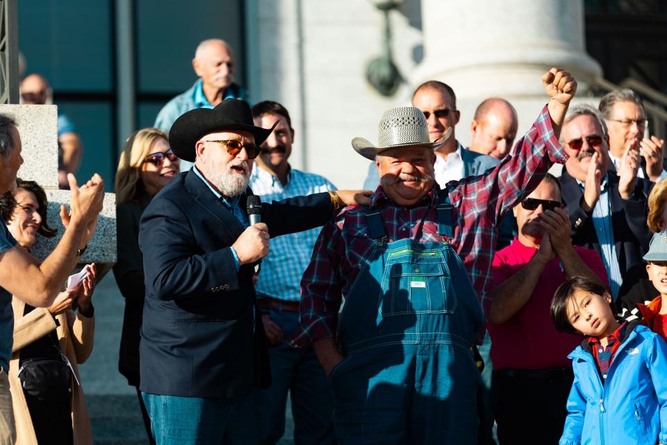 Doug Foxley, chair of The Golden Spike Foundation, introduces James Van Orman, the driver who brought the Golden Spike Monument to Utah, after the monument’s arrival in front of the Utah state Capitol in Salt Lake City on Monday, Oct. 23, 2023. The 43-foot-tall golden spike was commissioned as a public art piece by the Golden Spike Foundation to honor the tens of thousands of railroad workers who built the transcontinental railroad. | Megan Nielsen, Deseret News