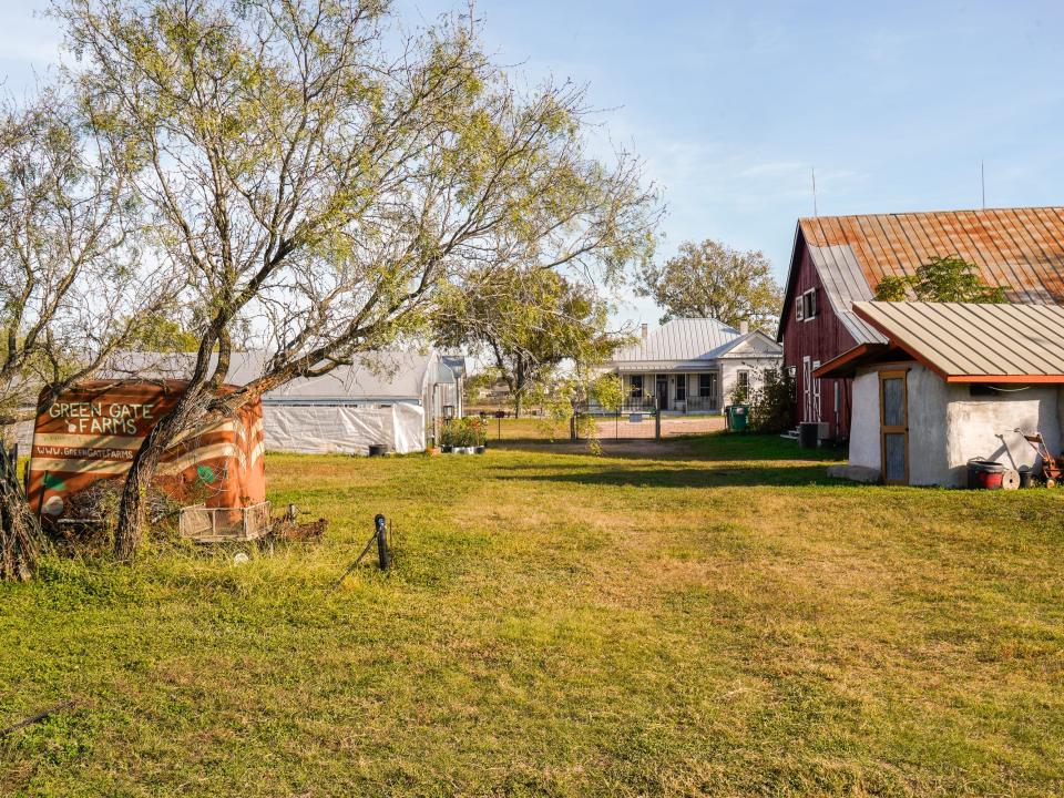 The barn house on the right and the greenhouse on the left