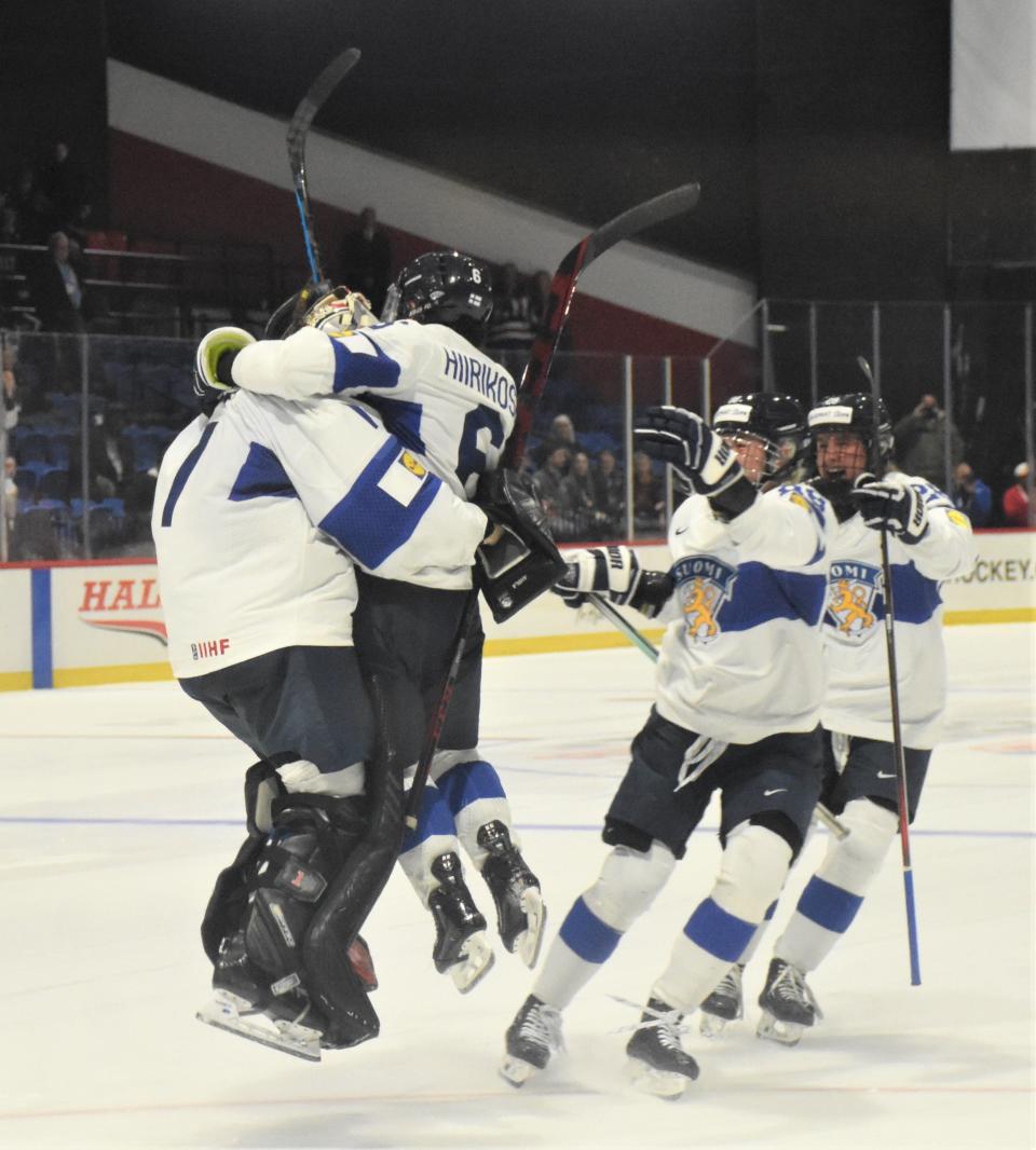 Finland goalie Sanni Ahola and teammate Jenni Hiirikoski (from left) leap into each others arms with more players coming to celebrate beating Czechia in a shootout in the bronze medal game at the IIHF Women's World Championship Sunday.