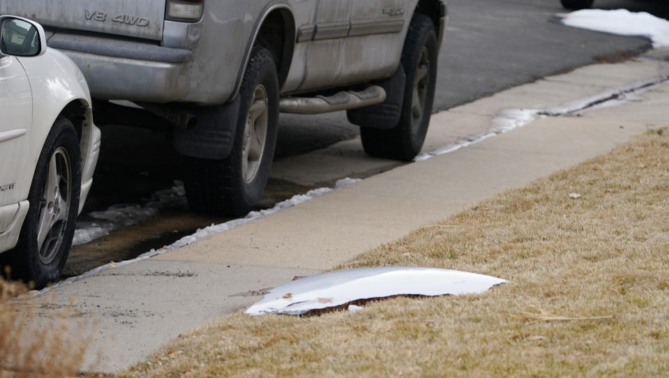 A piece of debris from a passenger airplane sits on the lawn of a home in Broomfield, Colo., after the plane shed parts while making an emergency landing at nearby Denver International Airport Saturday, Feb. 20, 2021. (AP Photo/David Zalubowski)