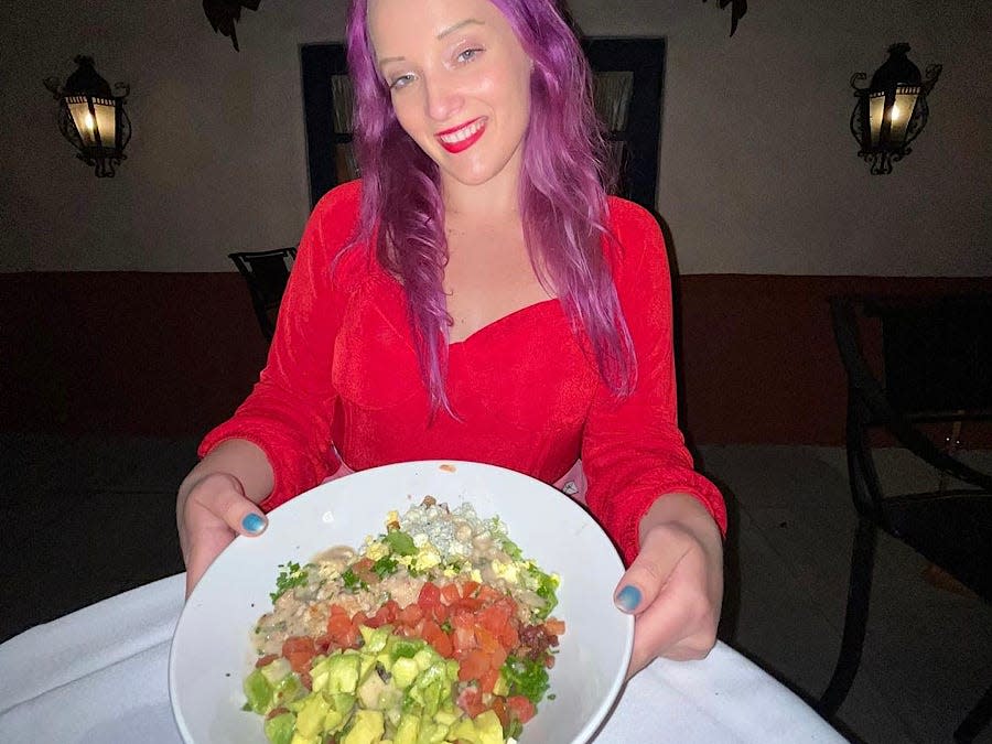 jenna posing with a cobb salad at hollywood brown derby at hollywood studios in disney world