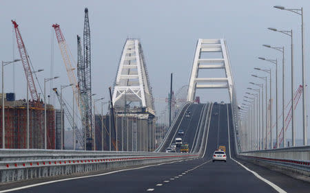 Vehicles drive along a bridge, which was constructed to connect the Russian mainland with the Crimean Peninsula across the Kerch Strait, May 16, 2018. REUTERS/Pavel Rebrov