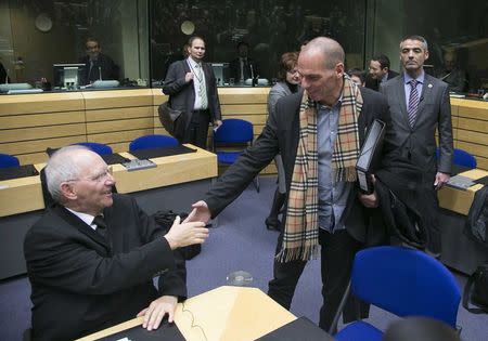 Greek Finance Minister Yanis Varoufakis (R) shakes hands with his German counterpart Wolfgang Schaueble (L) at an extraordinary euro zone Finance Ministers meeting to discuss Athens' plans to reverse austerity measures agreed as part of its bailout, in Brussels February 11, 2015. REUTERS/Yves Herman