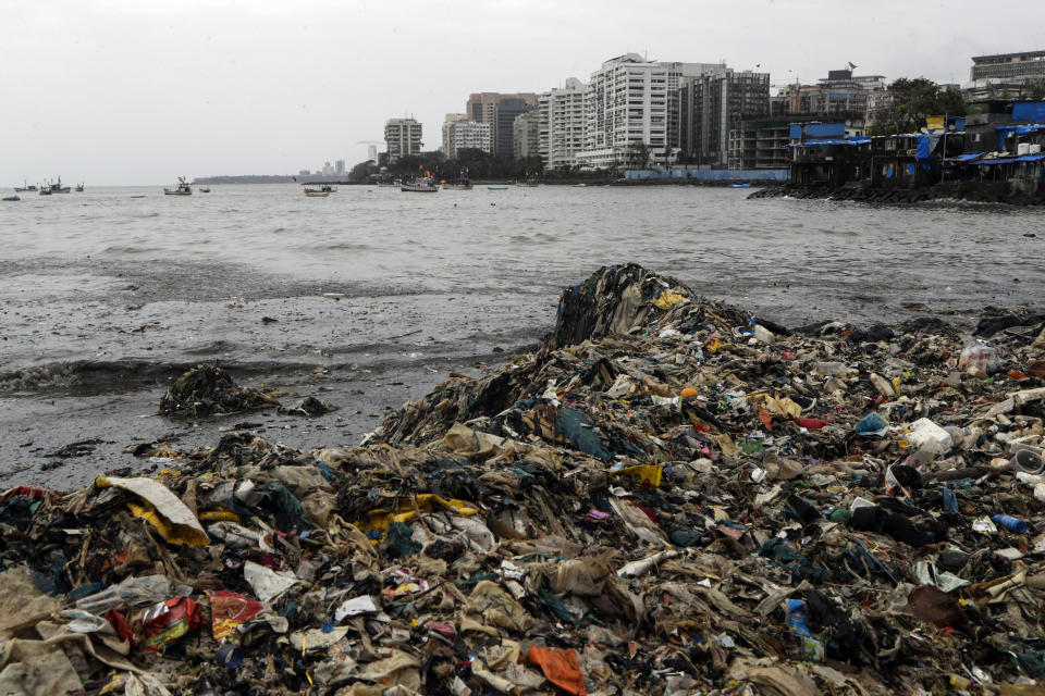 Plastic and other trash that got washed ashore on the Arabian Sea coast in Mumbai, India, Monday, Aug. 9, 2021. Earth’s climate is getting so hot that temperatures in about a decade will probably blow past a level of warming that world leaders have sought to prevent, according to a report released Monday that the United Nations called a “code red for humanity.” (AP Photo/Rajanish Kakade)