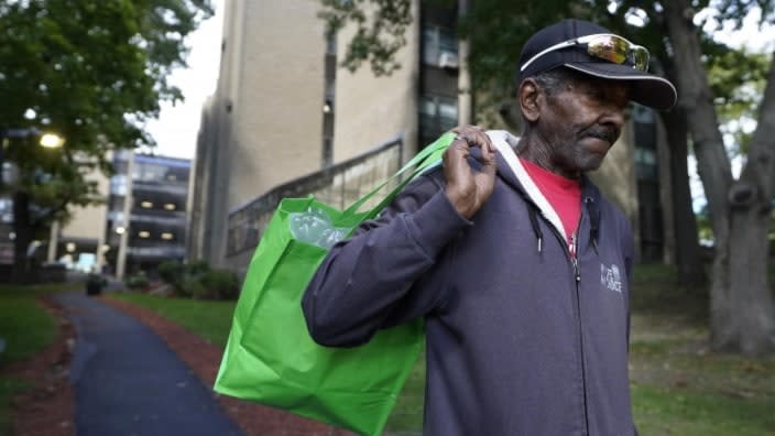 Steven Hamilton walks away from his apartment building in Boston on his way to a store last month. Hamilton was homeless for over three years before moving into the apartment in September. (Photo: Steven Senne/AP)