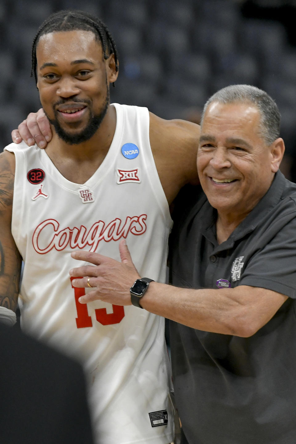 Houston forward J'Wan Roberts (13) and head coach Kelvin Sampson celebrate the team's 100-95 overtime win after a second-round college basketball game against Texas A&M in the NCAA Tournament, Sunday, March 24, 2024, in Memphis, Tenn. (AP Photo/Brandon Dill)