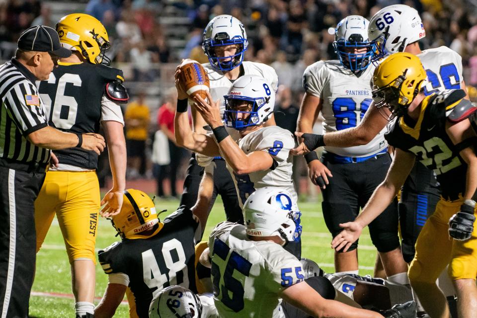 Quakertown quarterback Vince Micucci celebrates scoring a touchdown against Central Bucks West last fall.