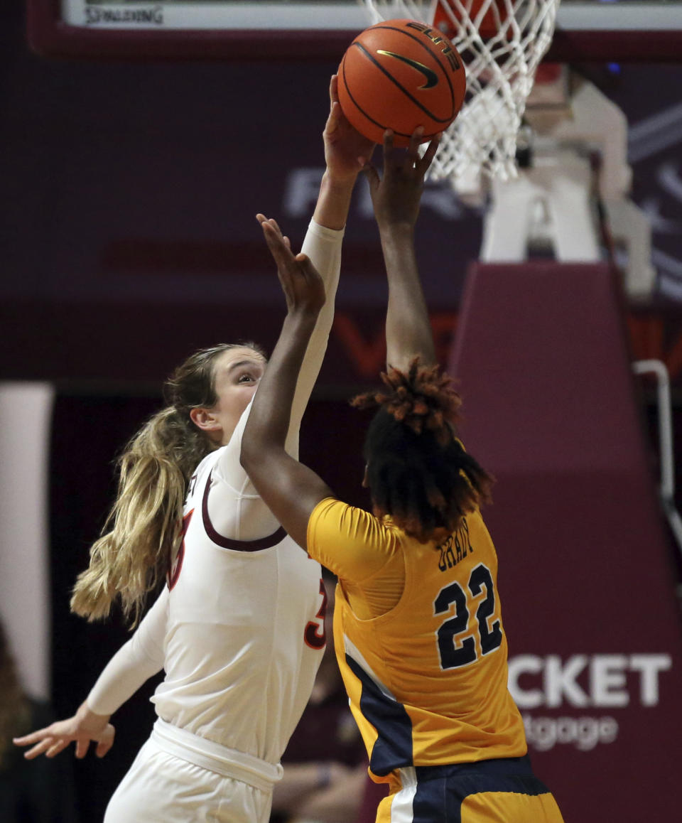 Virginia Tech's Elizabeth Kitley, left, blocks a shot by UNC-Greensboro's Isys Grady (22) in the first half of an NCAA college basketball game in Blacksburg, Va., Monday, Nov. 20 2023. (Matt Gentry/The Roanoke Times via AP)