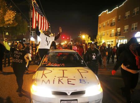 Protesters march in Ferguson, Missouri, October 11, 2014. REUTERS/Jim Young