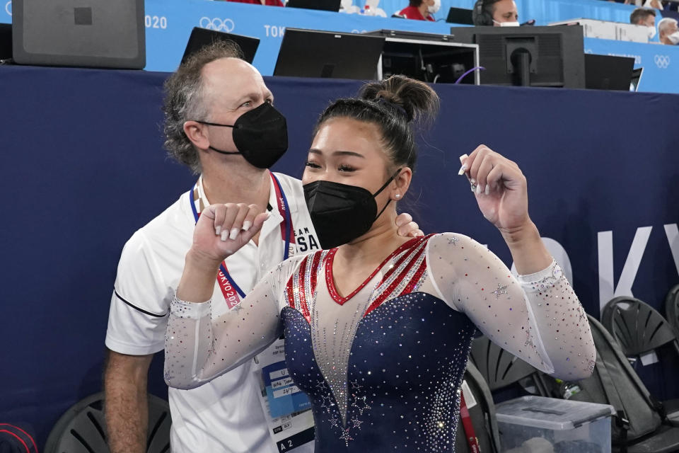 Sunisa Lee, of the United States, celebrates with her coach Jeff Graba after she won the gold medal in the artistic gymnastics women's all-around at the 2020 Summer Olympics, Thursday, July 29, 2021, in Tokyo. (AP Photo/Gregory Bull)