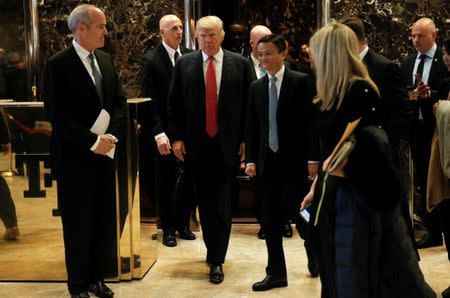 U.S. President-elect Donald Trump walks from an elevator with Alibaba Executive Chairman Jack Ma after their meeting at Trump Tower in New York, U.S., January 9, 2017. REUTERS/Mike Segar