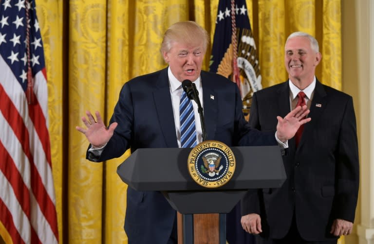 US President Donald Trump gives a speech, as Vice President Mike Pence looks on, at White House in Washington, DC, on January 22, 2017