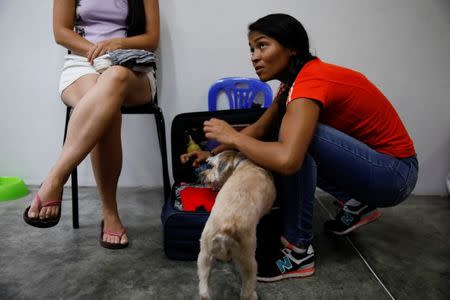 Alejandra Rodriguez packs her belongings before traveling by bus to Chile, at her home in Caracas, Venezuela, November 2, 2017. Alejandra Rodriguez, 23, accountant at an import company, said she had never wanted to leave Venezuela, and especially not on a bus, "I had never even thought of Chile in my entire life! But because of the situation I had to". REUTERS/Carlos Garcia Rawlins