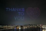 Drones fly over the Han river showing messages to support the country as measures to avoid the spread of the coronavirus disease (COVID-19) continue in Seoul