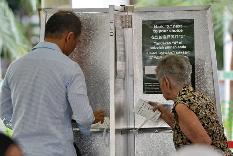 Residents in Punggol East queue at a polling station to cast their vote.