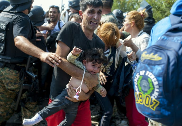 Migrants battle their way past Macedonian police as they attempt to enter Macedonia from Greece near the border town of Gevgelija on August 26, 2015