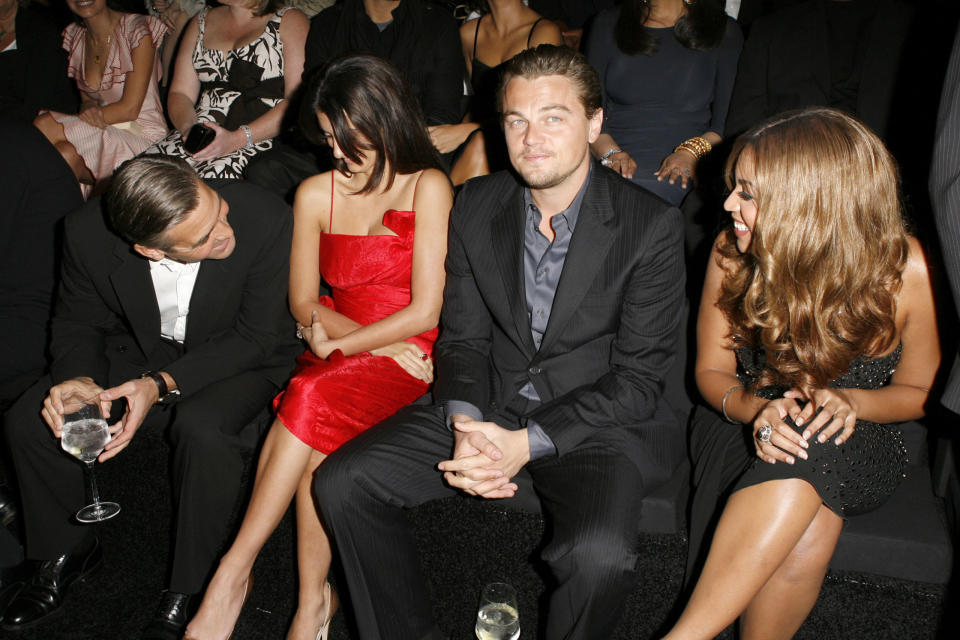 <p>George Clooney talks over two people to send his regards to Beyoncé during Giorgio Armani Privé<span>'s L.A. show. (Leo still keeps his cool.)</span></p>