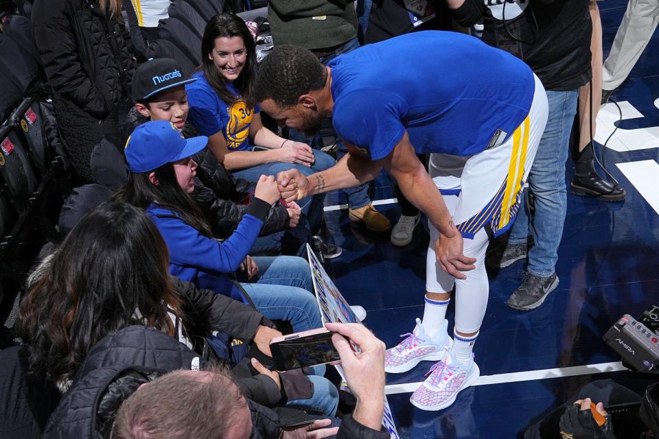 Stephen Curry #30 of the Golden State Warriors greets young fan, P.J. OBrien before the game