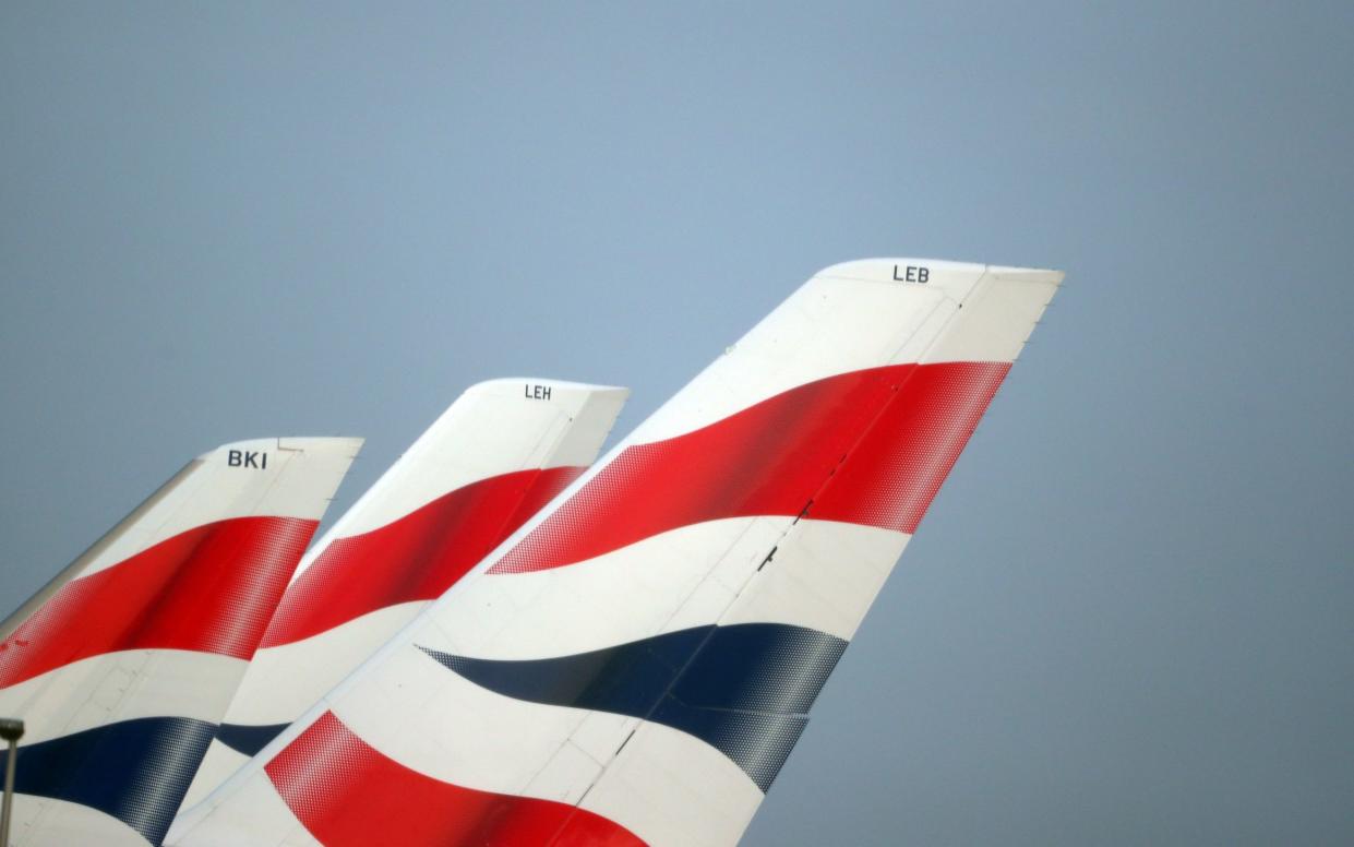 British Airways logos are seen on tail fins at Heathrow Airport in west London - HANNAH MCKAY