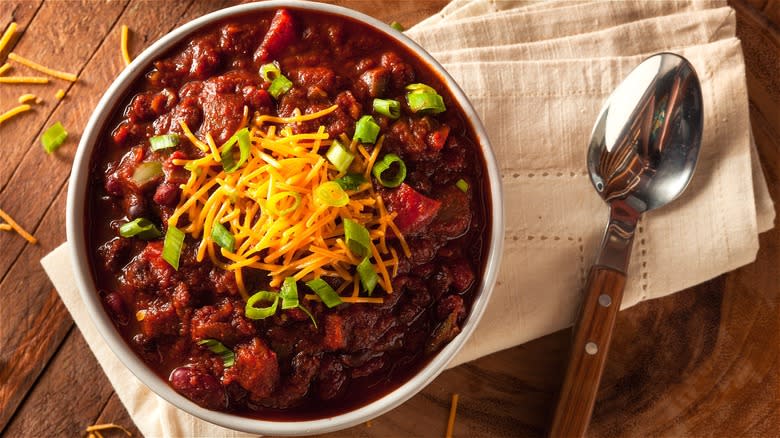 Bowl of chili with shredded cheese
