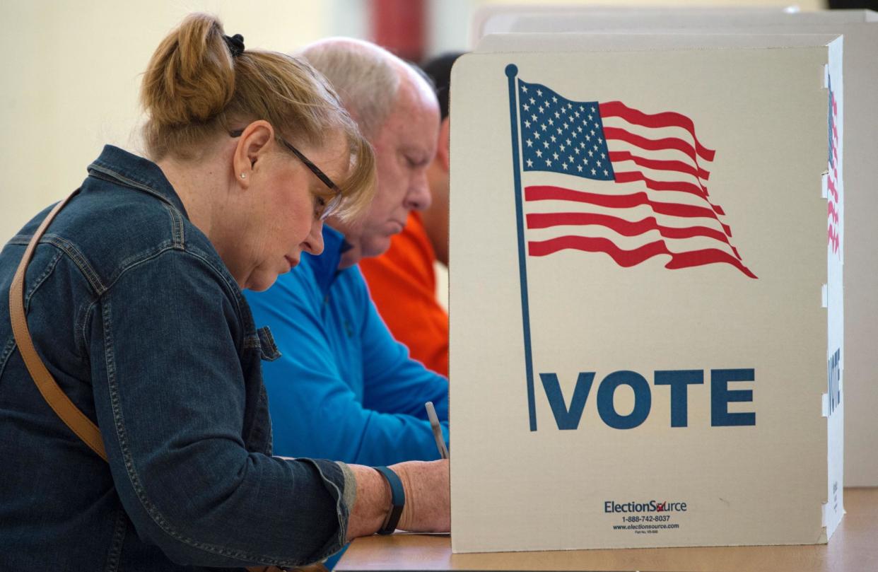 People cast their votes for US president November 8, 2016, at Centerville High School, in Centreville, Virginia: PAUL J. RICHARDS/AFP/Getty Images