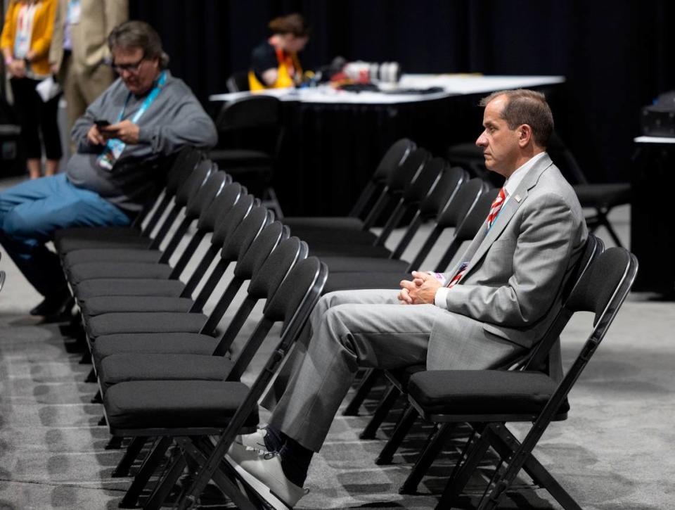ACC Commissioner Jim Phillips watches N.C. State coach Kevin Keatts, during his post game press conference following the Wolfpack’s loss to Purdue in the NCAA Final Four National Semifinal game on Saturday, April 6, 2024 at State Farm Stadium in Glendale, AZ.