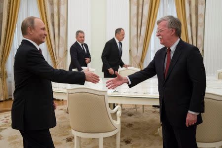 Russia's President Vladimir Putin (L) shakes hands with U.S. National Security Adviser John Bolton during a meeting at the Kremlin in Moscow, Russia June 13, 2018. Alexander Zemlianichenko/Pool via REUTERS