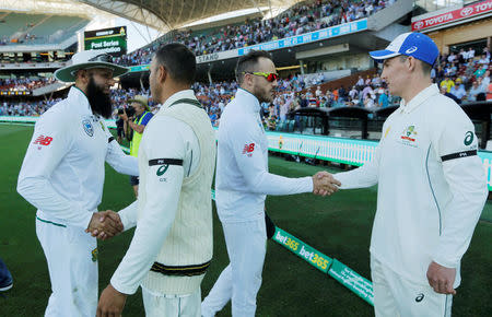 Cricket - Australia v South Africa - Third Test cricket match - Adelaide Oval, Adelaide, Australia - 27/11/16. South African players Hashim Amla (L) and captain Faf du Plessis (2nd R) shake hands with Australian's Usman Khawaja (2nd L) and Nic Maddinson at the end of play on the fourth day of the Third Test cricket match. REUTERS/Jason Reed