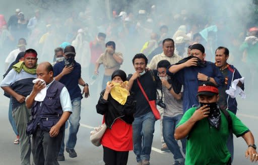 File photo shows demonstrators fleeing as Malaysian anti-riot police fire tear gas shells near Merdeka Square (Independence Square) in Kuala Lumpur. Malaysia's much dreaded colonial-era Sedition Act, which critics charged was abused to curb dissent, is to be repealed