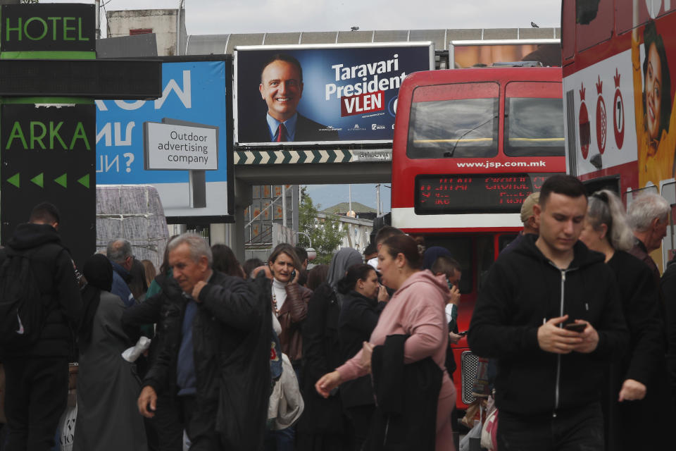 Election poster of Arben Taravari from an opposition ethnic Albanian party is pictured in a busy street in Skopje, North Macedonia, on Monday April 22, 2024. Voters go to the polls in North Macedonia on Wednesday April 24 for the first round of presidential elections, the seventh such election since the Balkan country gained independence from the former Yugoslavia in 1991, where seven candidates are vying for the largely ceremonial position. (AP Photo/Boris Grdanoski)