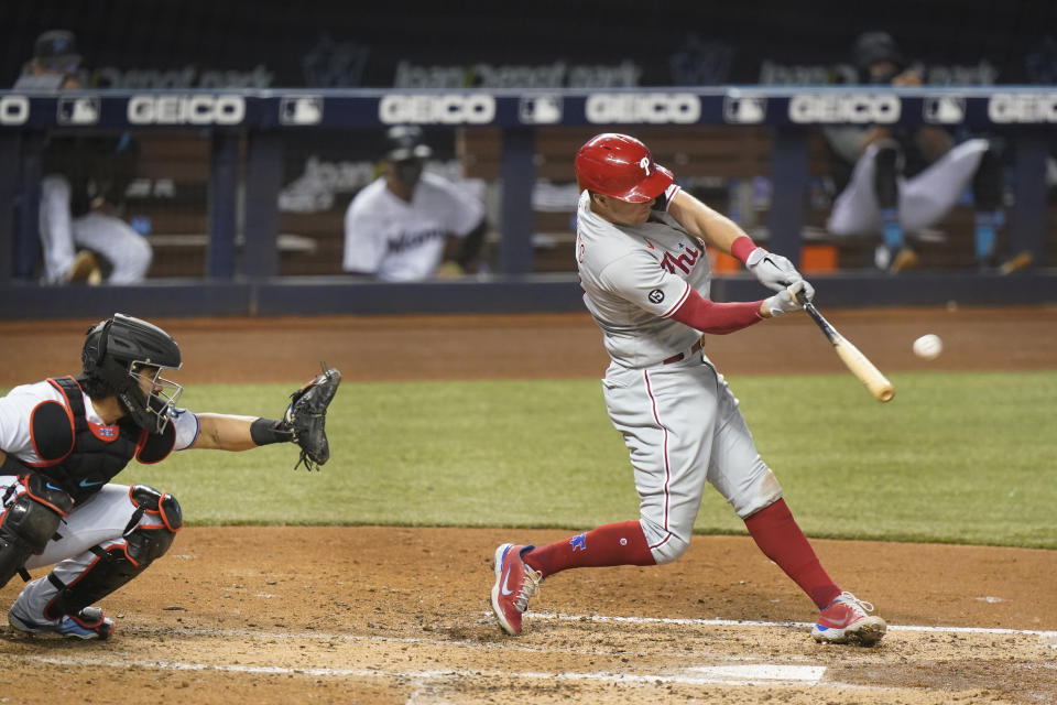 Philadelphia Phillies' Rhys Hoskins hits a two-run home run scoring Brad Miller during the fourth inning of a baseball game, Tuesday, May 25, 2021, in Miami. (AP Photo/Wilfredo Lee)