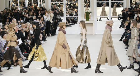 Models present creations by German designer Karl Lagerfeld as part of his Fall/Winter 2016/2017 women's ready-to-wear collection for fashion house Chanel at the Grand Palais in Paris, France, March 8, 2016. REUTERS/Gonzalo Fuentes