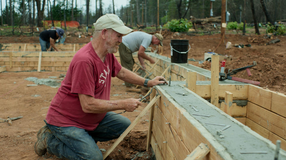 This image released by National Geographic shows documentary subject Steve "Woody" Culleton rebuilding his home in Paradise, Calif., in a scene from "Rebuilding Paradise." A new documentary by director Ron Howard captures a town's tough recovery following one of the most devastating wildfires in California's history. (National Geographic via AP)