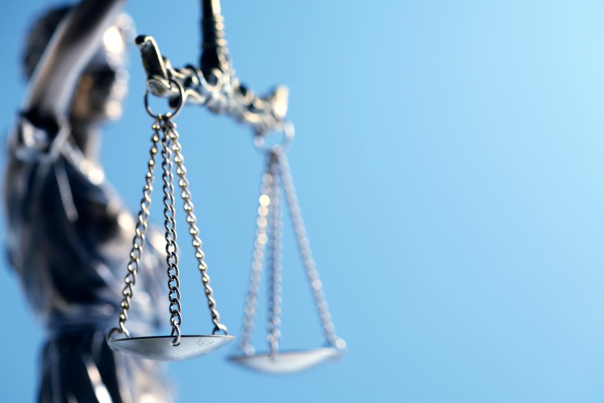 A close up and a low angle view of a statue of lady justice.