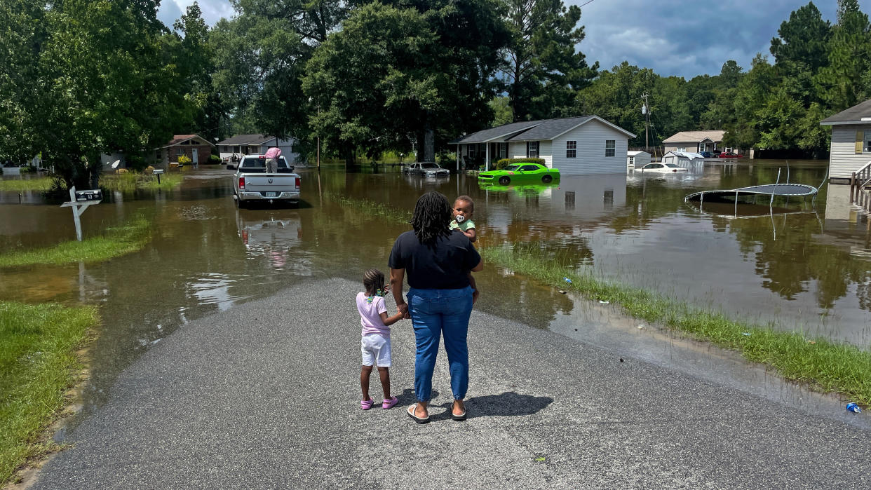 A woman and her children look at a neighborhood inundated by floodwaters in Statesboro, Ga., earlier this week.