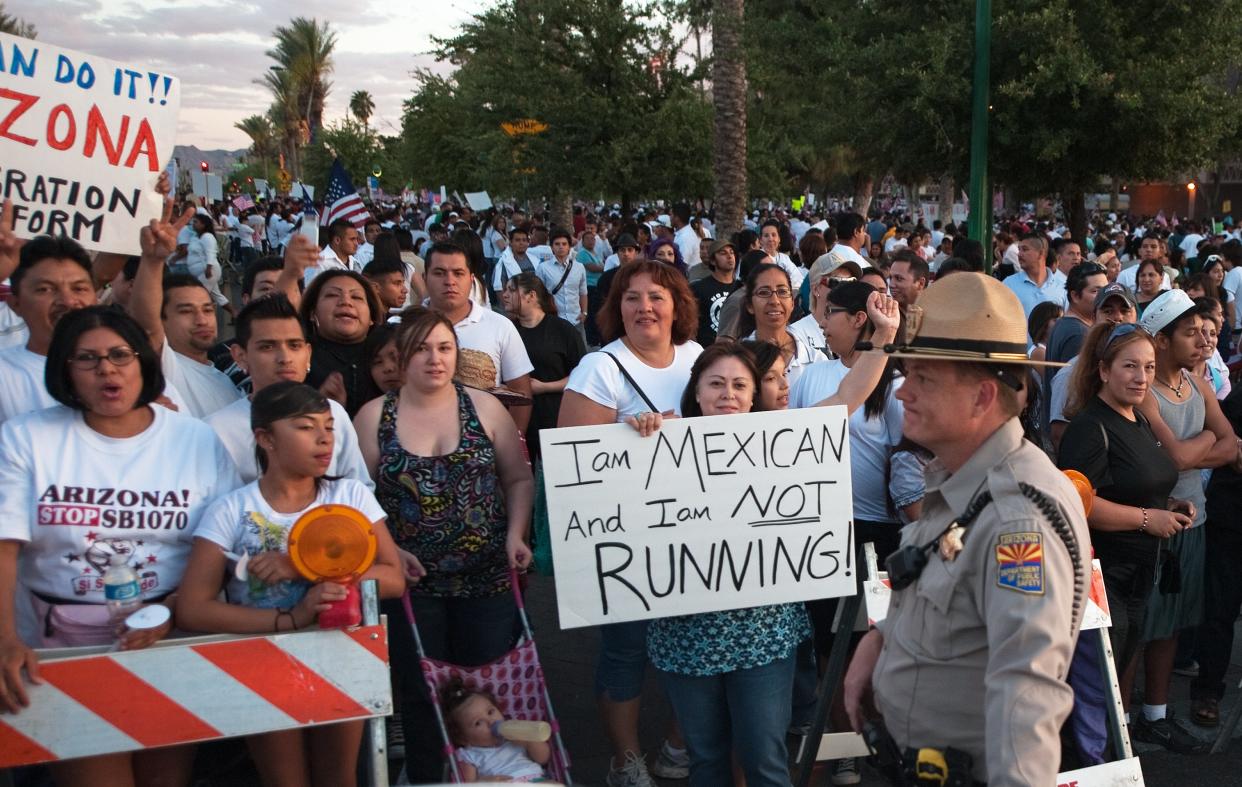 Protesters gather around the Arizona State Capitol against the State Senate bill 1070, which eventually passed and allowed law enforcement to inquire about people’s immigration status during arrests. (PAUL J. RICHARDS/AFP via Getty Images) (AFP via Getty Images)