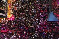 Revelers crowd in together to watch a performance on a passing sound truck popularly referred to as an electric trio, during the "Vumbora" Carnival street party in Salvador, Brazil, Saturday, Feb. 10, 2024. (AP Photo/Eraldo Peres)