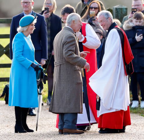 <p>Max Mumby/Indigo/Getty</p> Queen Camilla and King Charles III are greeted by The Right Reverend Graham Usher, Bishop of Norwich (2nd r) and The Reverend Canon Dr Paul Williams (r) as they attend the New Year's Eve Mattins service at St Mary Magdalene on Dec. 31, 2023.