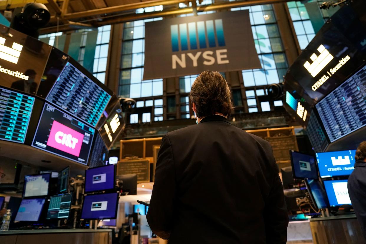 Traders work on the floor of the New York Stock Exchange at the opening bell January 25, 2022. - Wall Street stocks fell early January 25 following a deluge of mostly solid corporate earnings but a lower global growth forecast from the IMF. (Photo by TIMOTHY A. CLARY / AFP) (Photo by TIMOTHY A. CLARY/AFP via .)