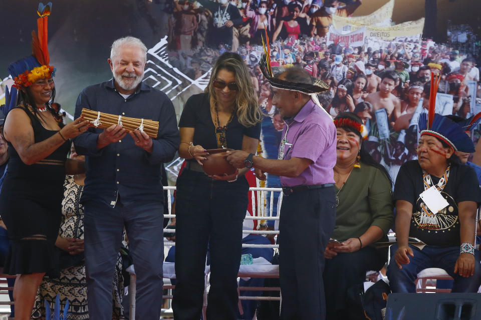 FILE - Brazil's President Luiz Inacio Lula da Silva and first lady Rosangela Silva, receive gifts from Indigenous leaders at the Caracarana Lake Regional Center in Normandia, on the Raposa Serra do Sol Indigenous reserve, in Roraima state, Brazil, March 13, 2023. (AP Photo/Edmar Barros, File)