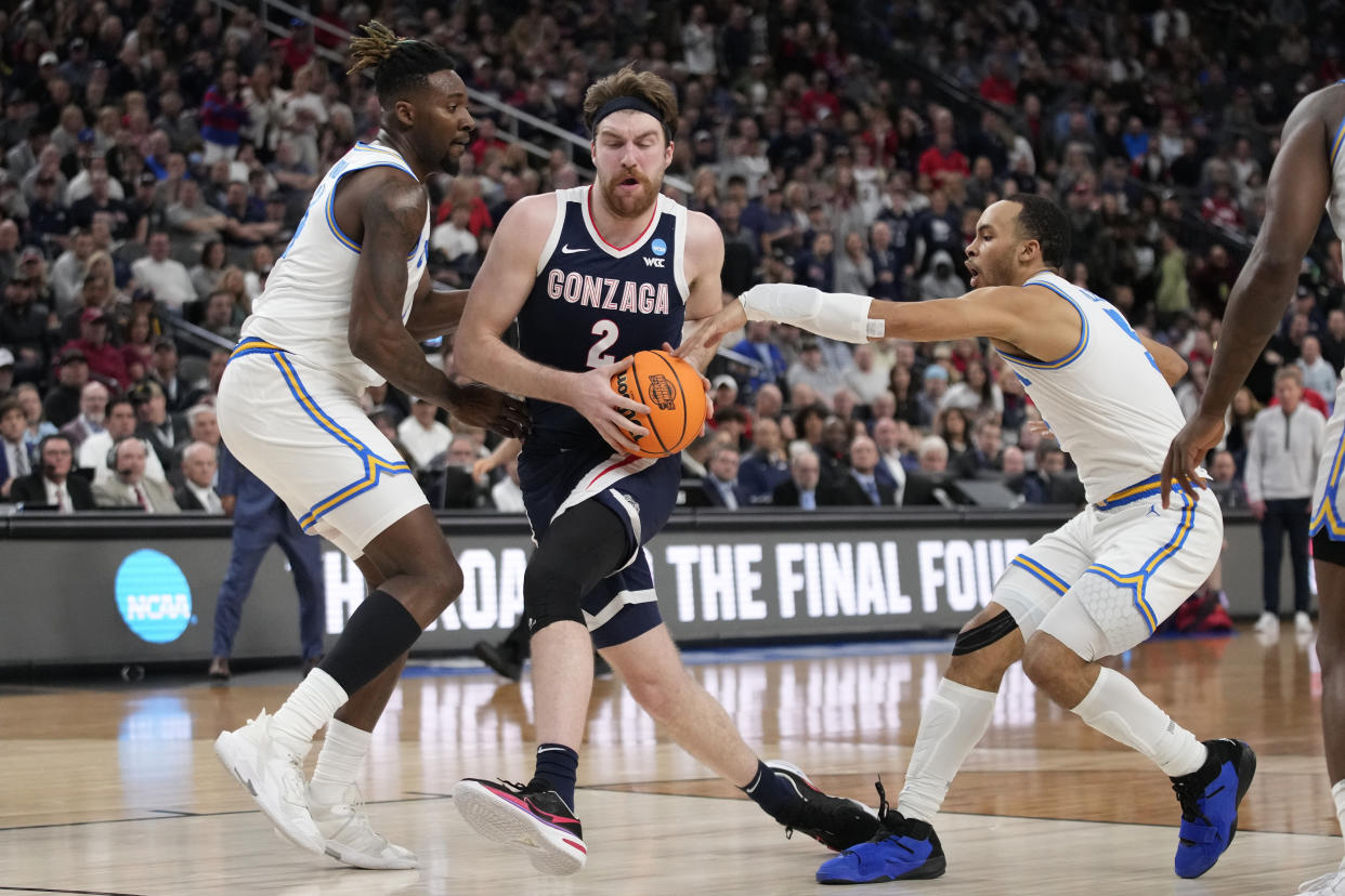 Gonzaga's Drew Timme (2) works towards the basket against UCLA's Kenneth Nwuba, left, and Amari Bailey in the first half of a Sweet 16 college basketball game in the West Regional of the NCAA Tournament, Thursday, March 23, 2023, in Las Vegas. (AP Photo/John Locher)