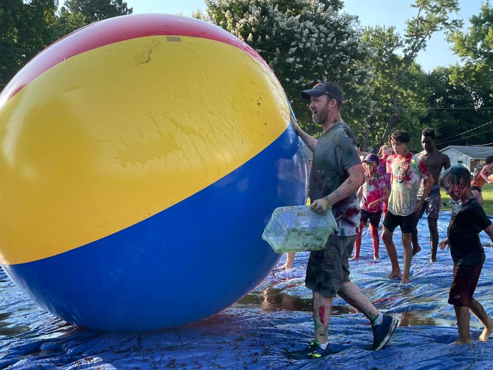 Director of Student Ministry Daniel Doubleday leads the kids in a game of slime ball at a slime battle at Concord United Methodist Church on Wednesday, June 23, 2022