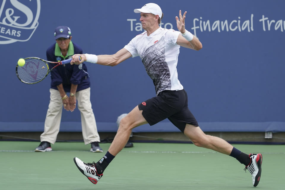 Kevin Anderson, of South Africa, returns to David Goffin, of Belgium, at the Western & Southern Open tennis tournament, Friday, Aug. 17, 2018, in Mason, Ohio. (AP Photo/John Minchillo)
