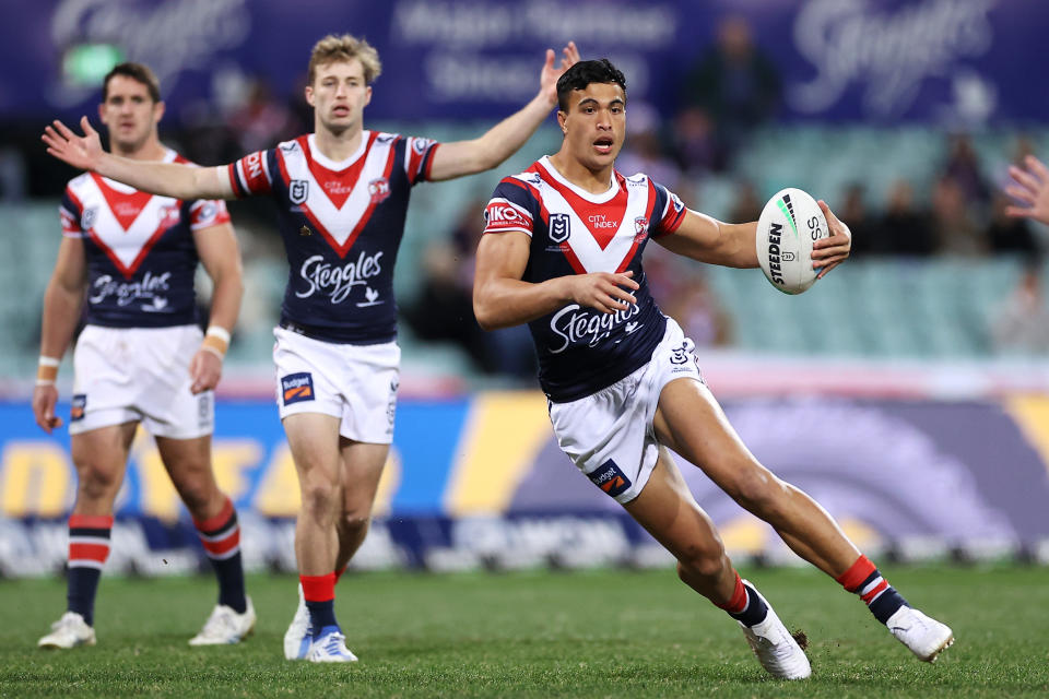 Seen here, Joseph Suaalii running with the ball for the Roosters during an NRL game against the Melbourne Storm. 